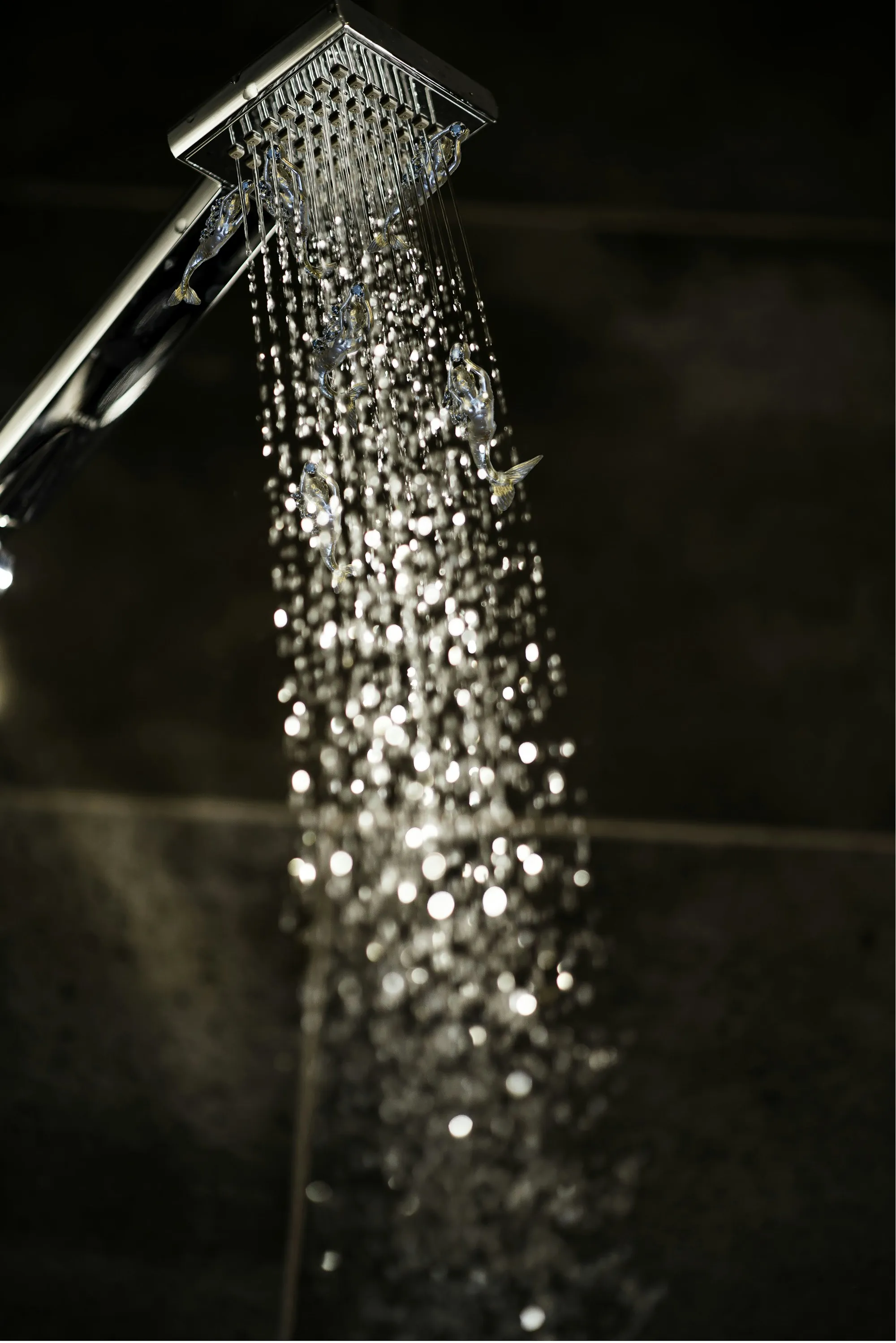 Close view of water streaming from a shower head