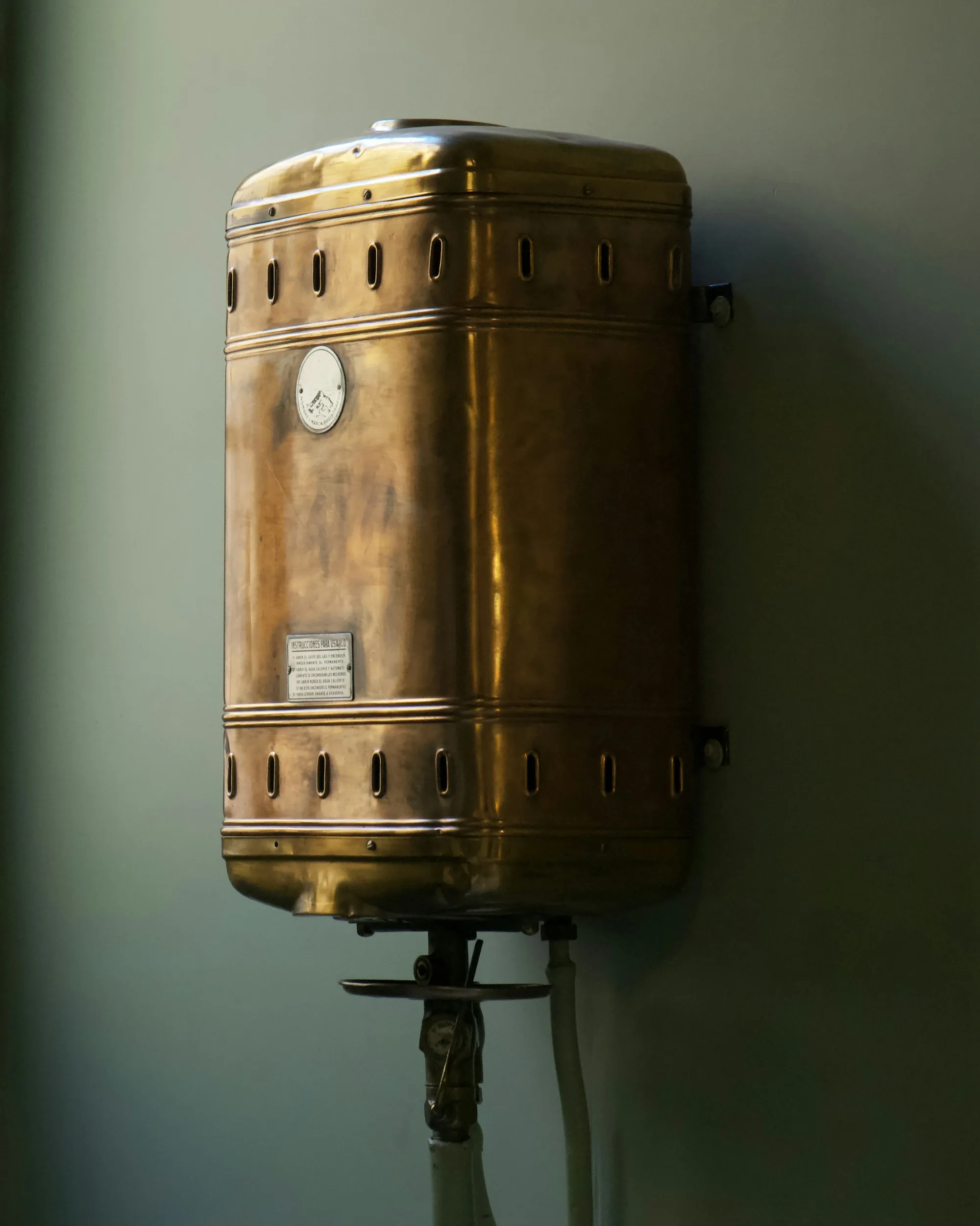 Copper water heater tank with a worn mineral finish