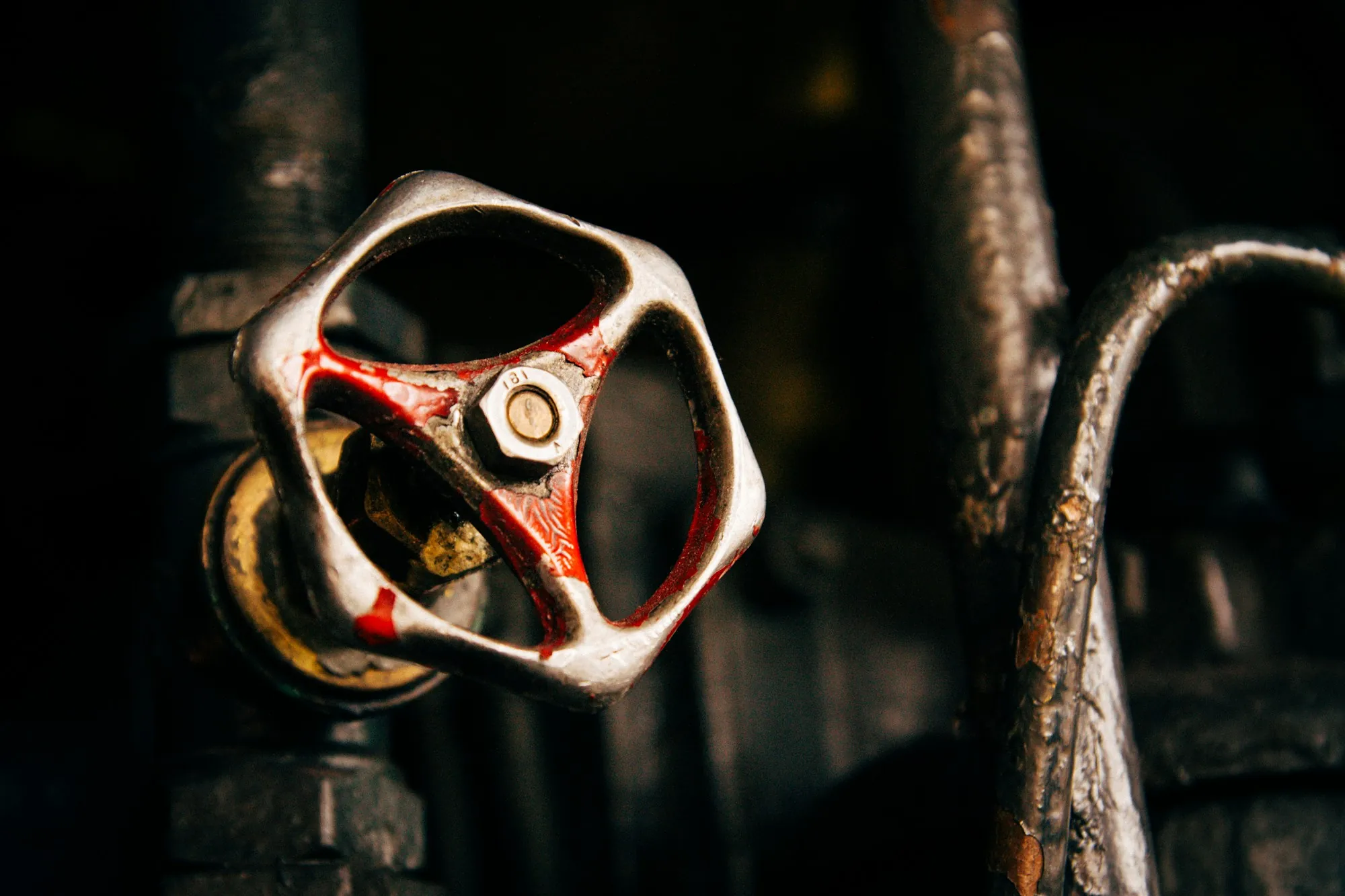 Rust-covered valve handle on an old water pipe