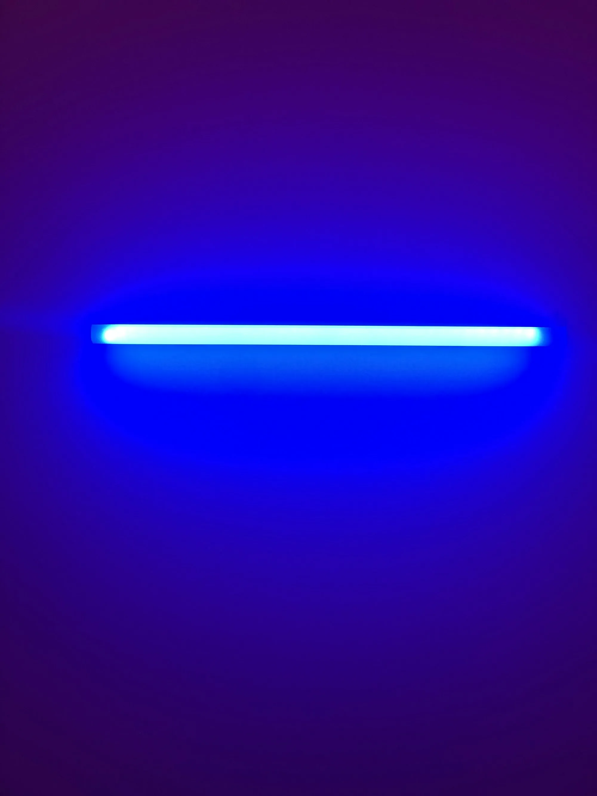 Glowing ultraviolet lamp against a blue background